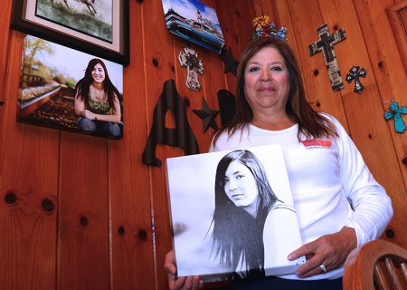 Ana Nicks is in Amanda's Home, named for her daughter. She is flanked by photos of her daughter, Amanda, who died from a heroin overdose in 2016. Nicks is working to create additional programs for those afflicted by drugs.